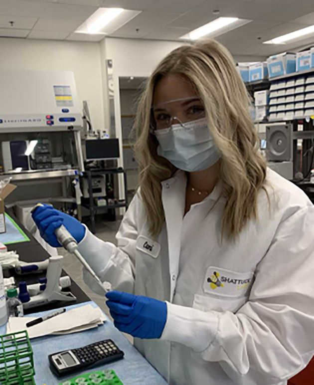 female lab tech reviewing results at desk