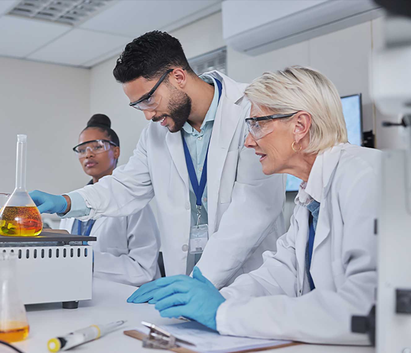 Scientists in lab reviewing results