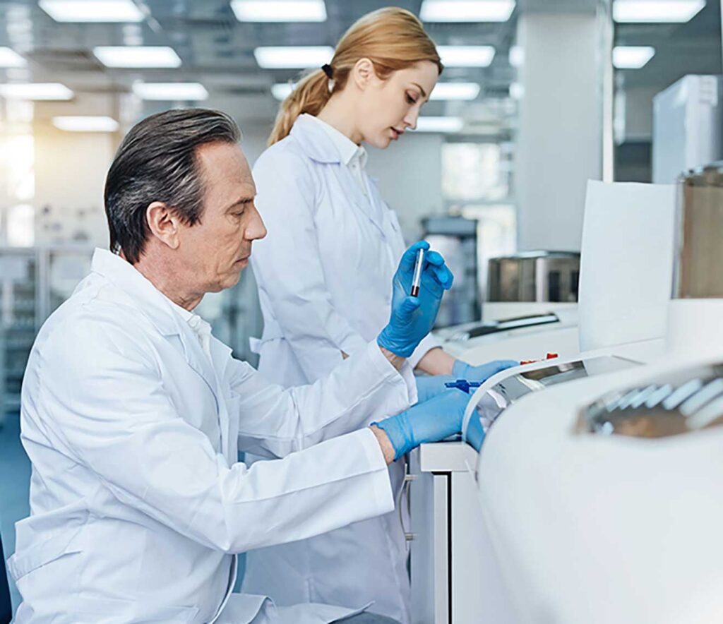 Two scientists in lab reviewing test from a machine